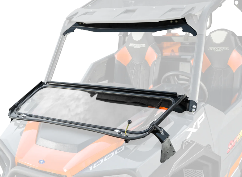 A Polaris General Flip Down Glass Windshield is partially open on a black and orange off-road utility vehicle, displaying the seats and steering wheel. The windshield uses side hinges for folding and attaches securely to the vehicles front frame.