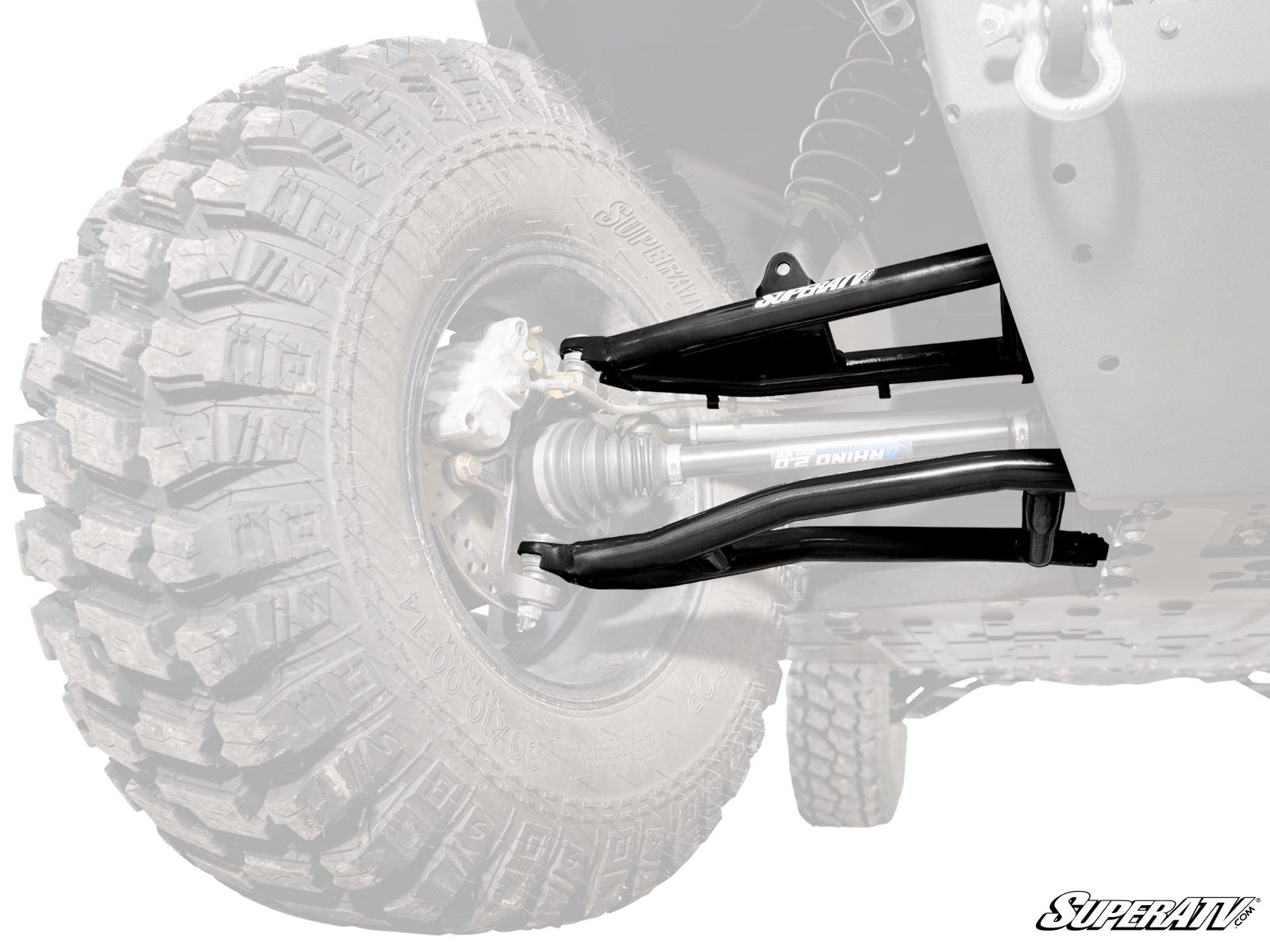 Close-up of Gravely Atlas JSV High-Clearance 2 Forward Offset A-Arms with a Rhino 2.0 axle, large treaded tire, brake disc, and chassis; suspension components are highlighted while other parts remain translucent. SuperATV logo in the lower right corner.
