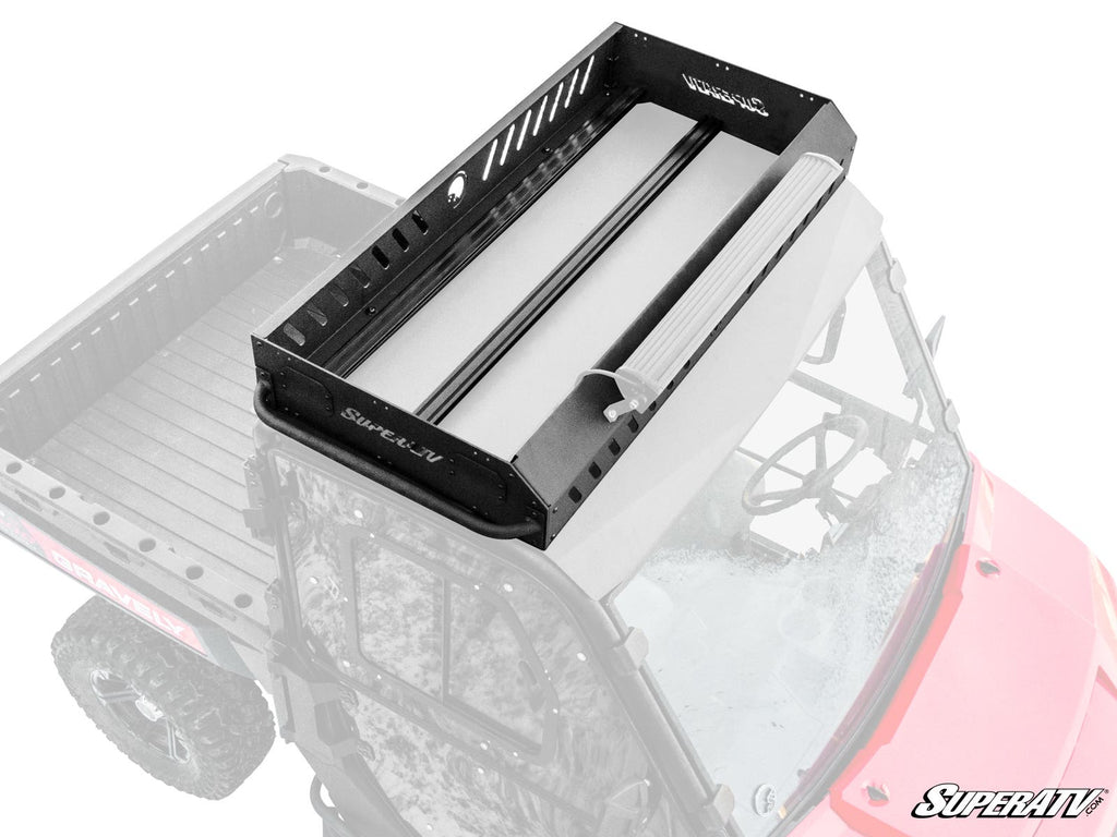 A Gravely Atlas JSV 3400 Outfitter Roof Rack is mounted on a red side-by-side utility vehicle. The above angle highlights the racks metal build and slotted sides, with part of the windshield and steering wheel in view.