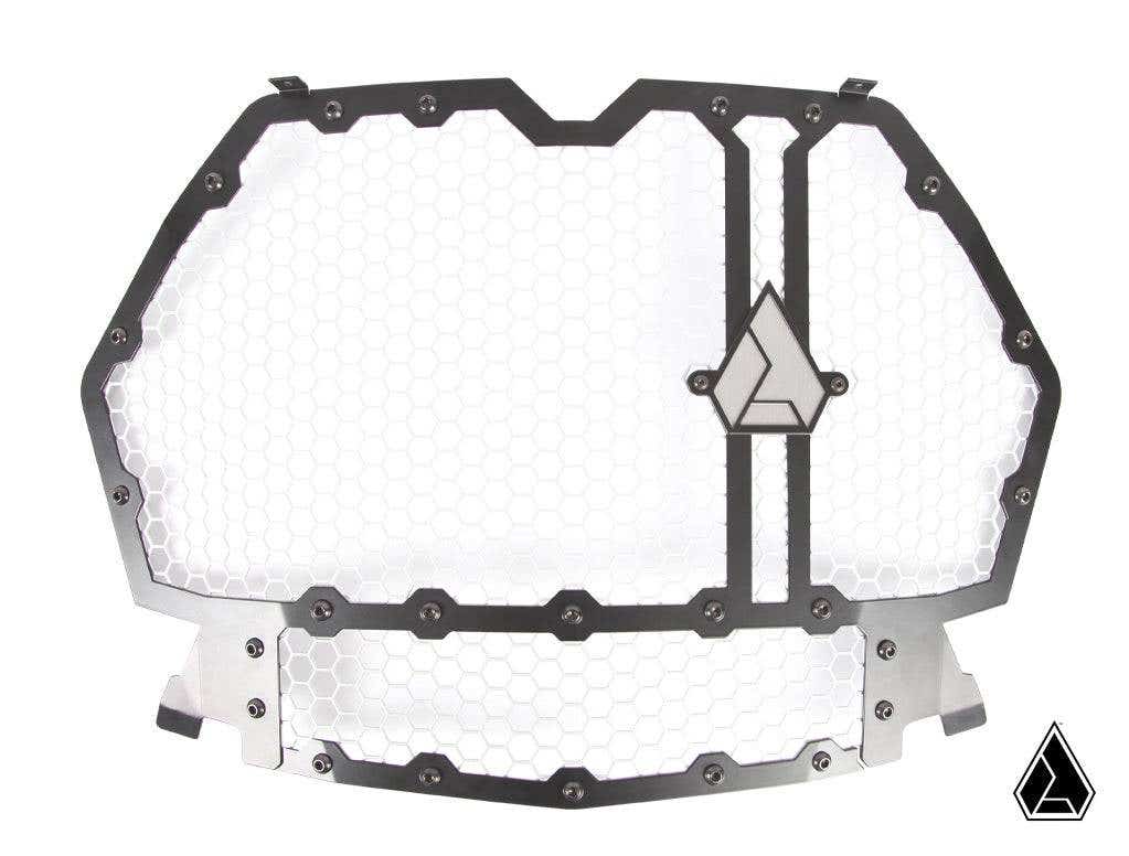 The Assault Industries Hellfire Modular Grill (Fits: RZR Turbo S / 19+ XP 1000, Turbo) features a hexagonal metal grille with honeycomb mesh, a dark bolted frame, and triangle logos on the right and bottom right; background is plain white.