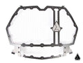 The Assault Industries Hellfire Modular Grill (Fits: RZR Turbo S / 19+ XP 1000, Turbo) features a hexagonal metal grille with honeycomb mesh, a dark bolted frame, and triangle logos on the right and bottom right; background is plain white.
