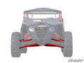 Front view of an off-road vehicle with most body faded out, highlighting bright red Can-Am Maverick X3 High-Clearance A-Arms and shocks labeled SuperATV. Deep-tread tires visible; SuperATV logo in bottom right corner.