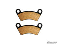 Two curved, tan Honda ATV Rear Disc Brake Pads for SuperATV Rear Disc Brake Kits with black edges and round mounting holes at each end, arranged horizontally on a white background. The SuperATV logo appears in the bottom right corner.