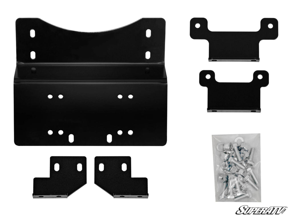 The Honda Pioneer 700 Winch Mounting Plate kit includes six black metal bracket pieces in assorted shapes and sizes, plus a clear plastic bag of screws and hardware, all displayed on a white background. The SuperATV logo is in the bottom right corner.