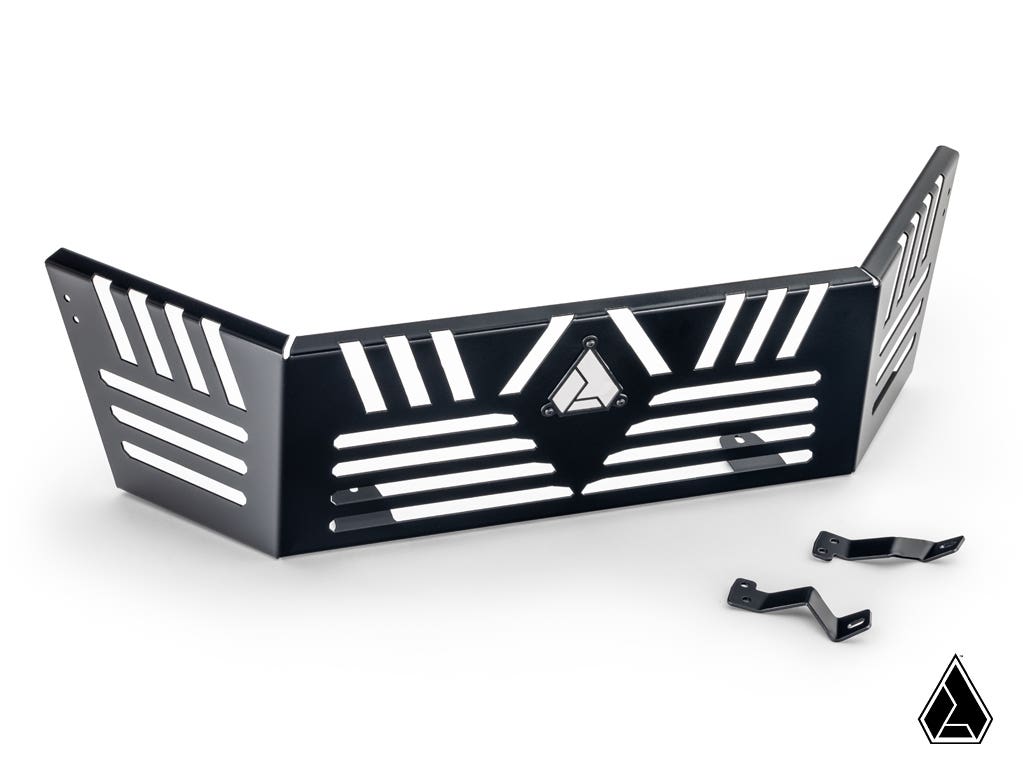 The Assault Industries Honda Talon 1000 Bed Enclosure is a black metal panel with angular lines, multiple slotted cutouts, and a geometric logo at the center. Two small black metal brackets are included. The background is plain white.