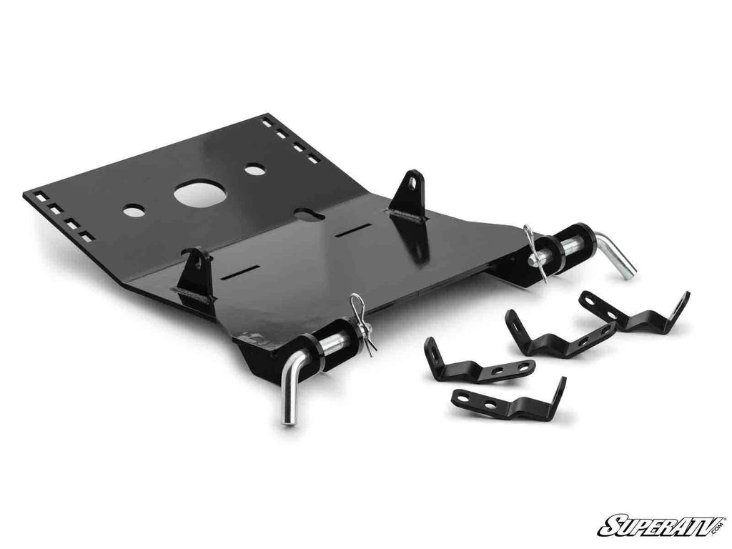 A black metal Honda Talon 1000 Plow Pro Snow Plow Mount by SuperATV, with brackets, pins, and hooks arranged on a white background. Parts include a large rectangular plate with side flanges and three smaller bracket pieces for ATV assembly.