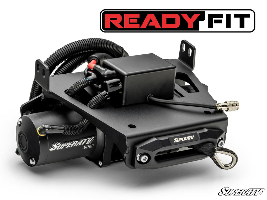 A Honda Talon 1000 Ready-Fit Winch kit with a black metal housing, cables, and hook is displayed on a white background. The SuperATV and READY FIT logos are visible. Electrical wires are neatly arranged in its rugged design.