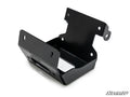 The Honda Rancher Winch Mounting Plate is a black metal bracket with angled sides, multiple screw holes, and a flat base. It features a durable, slightly glossy finish and is shown on a white background with the SuperATV logo in the corner.
