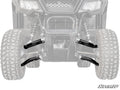 Front view of the Honda Pioneer 520 High-Clearance 1 Forward Offset A-Arms suspension system, featuring rugged black A-arms and shocks between large tires. The vehicle’s grill and headlights are visible, with the SuperATV logo in the bottom right corner.