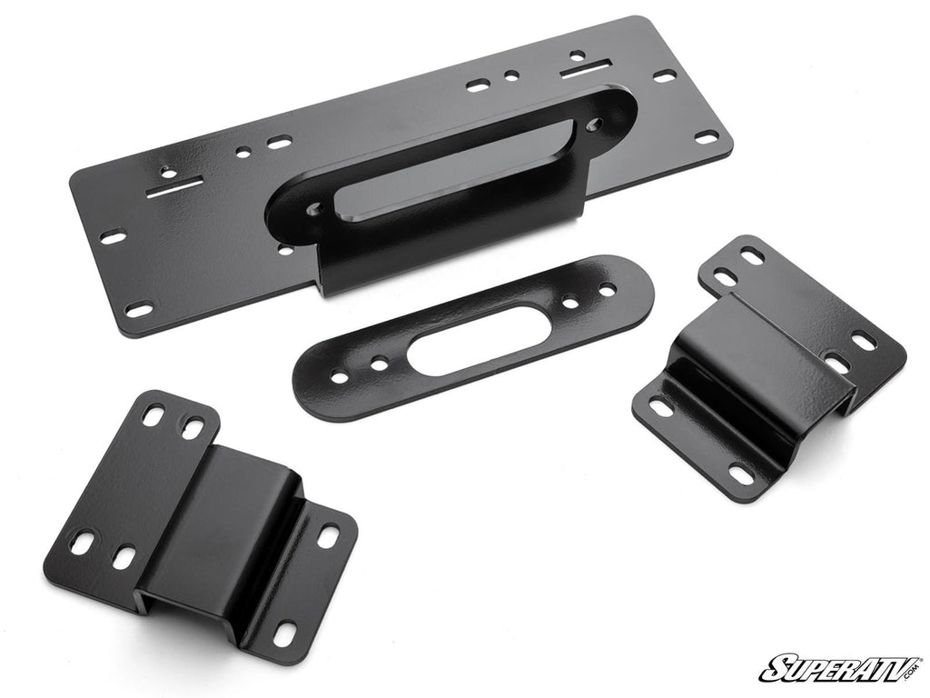 Four black metal brackets of different shapes and sizes, each with multiple bolt holes, are arranged on a white background. They have smooth, shiny surfaces. The SuperATV logo is in the bottom right. Product: Honda Pioneer 500 Winch Mounting Plate.