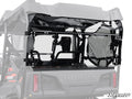 Close-up of a Honda Pioneer 700-4 Rear Windshield by SuperATV, featuring a black mesh window panel with metal framing and attachment hardware. The partially transparent panel offers a view into the vehicle’s interior, with SuperATV branding visible.