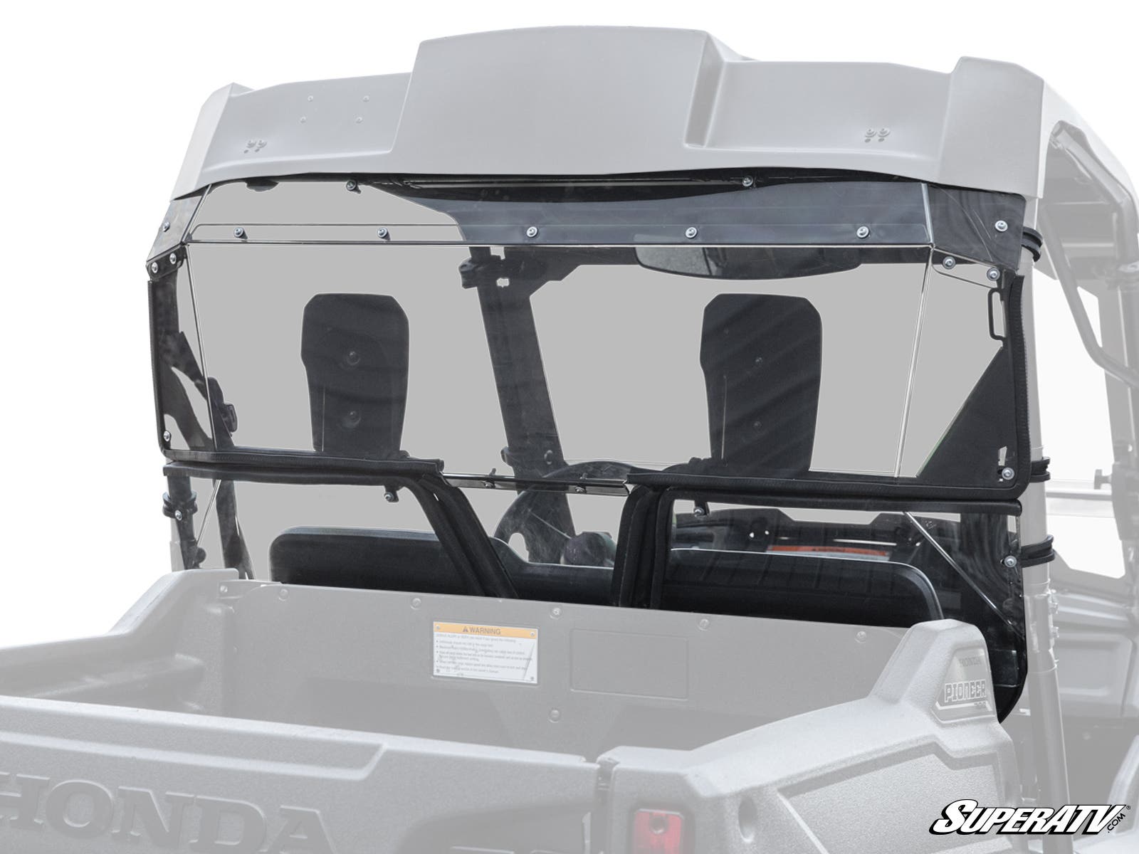 A clear Honda Pioneer 700 Rear Windshield is installed on a gray Honda utility vehicle, covering the space behind the two headrests and secured with black fasteners. The truck bed, roll cage, and SuperATV logo in the lower right are visible.