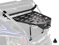 The Assault Industries Honda Talon 1000 Adventure Rack, a black metal cargo rack with a grated design and adjustable arms, is mounted on the rear roll cage of a blue Honda off-road vehicle above the bed for extra storage.