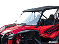 A red Honda Talon 1000 off-road vehicle with a clear full windshield, black roof, bold black graphics, rugged tires, red suspension springs, and mesh side door on a plain white background. SuperATV logo appears in the bottom right corner.