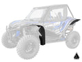 A blue and black Honda Talon 1000, equipped with Assault Industries Low-Profile Fender Flares shown in color on the front and rear, appears with a faded body. The manufacturers logo is displayed in the bottom right corner.