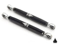 Two black Assault Industries Heavy Duty Rear Sway Bar End Links for Honda Talon, featuring silver rod ends and a geometric white and silver logo at the center, are displayed diagonally on a white background. A small triangular logo is in the lower right c