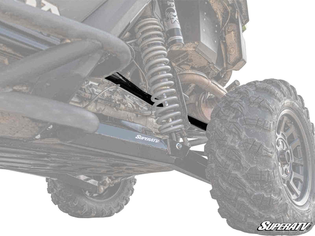Low-angle view of a Honda Talon 1000R’s rear suspension highlights the coil spring, shock absorber, and durable Honda Talon 1000R Rear A-arms. The lifted setup with large, rugged tire is built for rough terrain. Faded, high-contrast image effect.