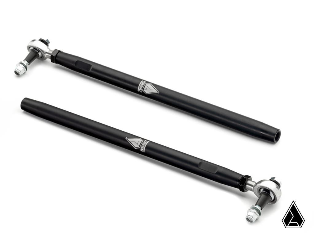 Two black Assault Industries UHD 7075 Tie Rods for the Honda Talon 1000X, each with silver adjustable joints and a central triangular logo, are laid parallel on a white background. The same logo appears in the image’s bottom right corner.