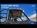 A blue Polaris Ranger XP with a new Gravely Atlas JSV 3400 Plastic Roof is parked outdoors under a bright sky. White text on the left reads: Plastic Roof Install - Polaris Ranger.