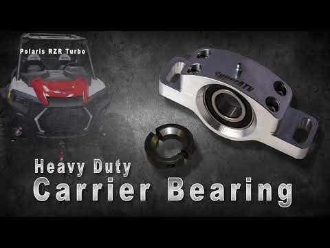A Polaris RZR Trail S 900 Carrier Bearing with a separate metal ring is displayed on a dark textured background. Heavy Duty Carrier Bearing is written below, and a Polaris RZR Turbo off-road vehicle appears in the upper left corner.