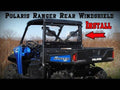 A blue Polaris Ranger XP utility vehicle is parked in a grassy field. Large text reads Polaris Ranger XP 1000 Rear Windshield Install, with an arrow pointing to the rear windshield on the vehicle.