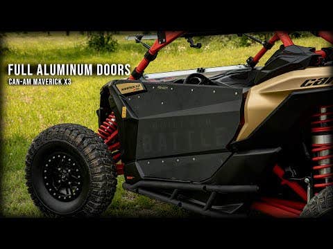 A close-up of Can-Am Maverick X3 shows its Aluminum Doors, rugged tires, red suspension coils, and a black and gold color scheme parked on grass. Text: “Can-Am Maverick X3 Aluminum Doors.”.