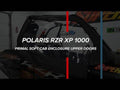 A Polaris RZR S 1000 utility vehicle appears in a garage with Primal Soft Cab Enclosure Upper Doors installed. White text reads: POLARIS RZR S 1000 PRIMAL SOFT CAB ENCLOSURE UPPER DOORS, accented by red and blue vertical lines.