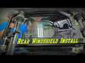 A person in a blue shirt installs a Polaris RZR XP Turbo Rear Windshield on an off-road vehicle inside a garage. Bold yellow text, “Rear Windshield Install,” spans the lower part of the image.