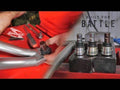 Wearing a red shirt, a person installs a Polaris RZR XP 900 Ball Joint into a gray suspension arm on a red workbench. Tools and SuperLube are nearby, while three ball joints are lined up on a block. Text reads: BUILT FOR BATTLE.