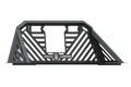 The 2009-2020 Ram 1500 Stealth Headache Rack (Non Toolbox Bed) in textured black features an angular design with diagonal and horizontal bars, a centered Road Armor shield logo plate, and reinforced triangular side supports.