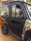 A Polaris Ranger 900/1000/XP/DIESEL or 570 (’15-16) with Full Steel Doors by Armor Tech is parked indoors, featuring black armored doors, camouflage panels, big tires, and tinted windows. Mounted deer heads and gear shelves are in the background.
