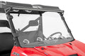 A red Polaris Ranger 1000 with a Vented Full Windshield (Scratch Resistant), five round LED lights below the glass, and a long LED bar on top. The steering wheel and headrest are visible through the windshield.