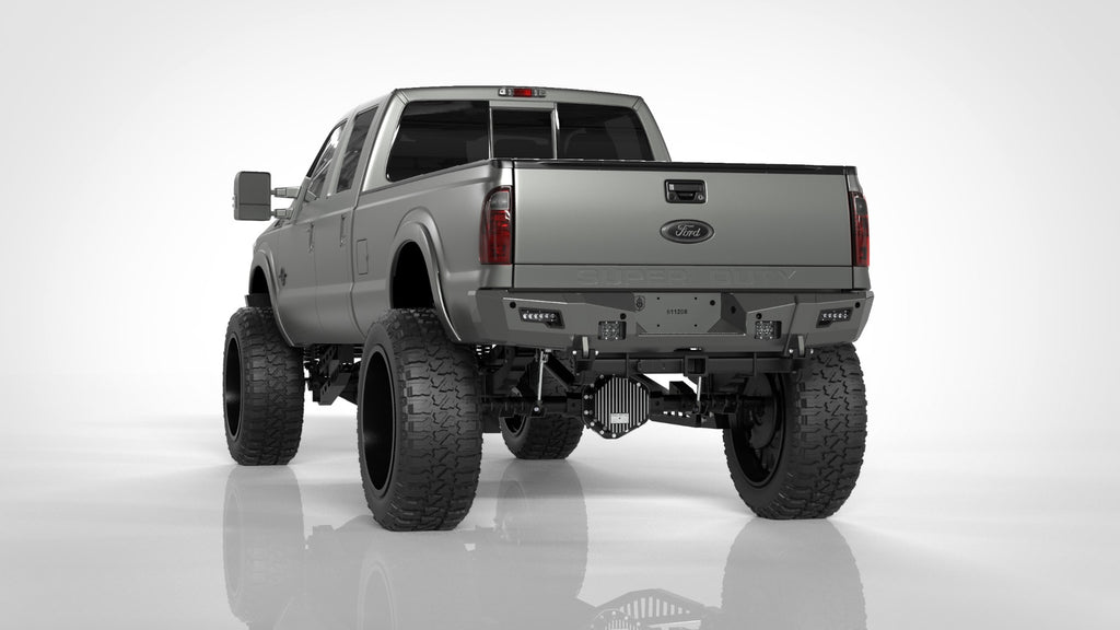 A silver Ford F-250 (2011-2016) with large off-road tires, lifted suspension, dark tinted windows, and visible rear lights is shown from the rear on a white background, featuring the Identity Rear Bumper Full Kit with center section and accent lights.