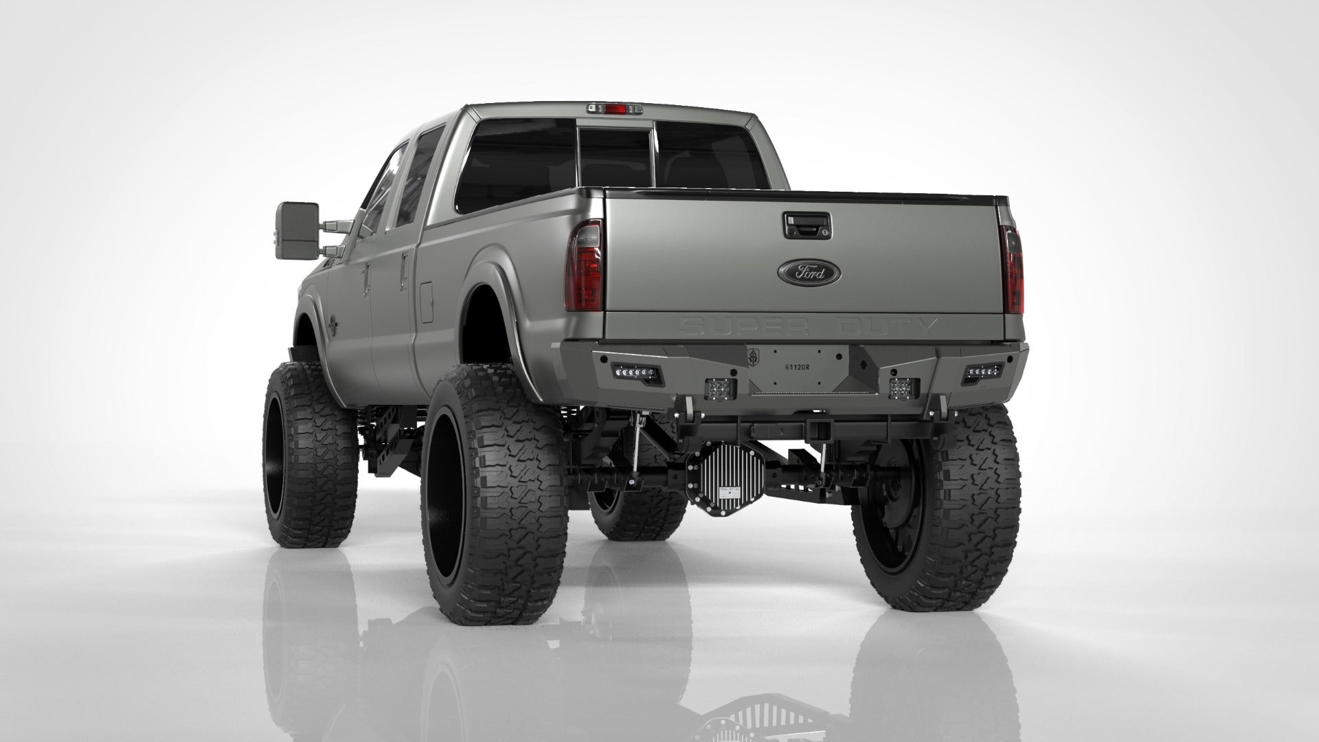 A silver Ford F-250 (2011-2016) with large off-road tires, lifted suspension, dark tinted windows, and visible rear lights is shown from the rear on a white background, featuring the Identity Rear Bumper Full Kit with center section and accent lights.