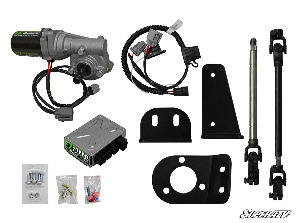 The John Deere Gator 550 Power Steering Kit is displayed with a motor, wiring harness, control box, brackets, two steering shafts, mounting hardware, and small parts—all neatly arranged on a white background featuring the SuperATV logo.