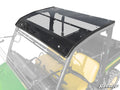 The John Deere Gator 835/865 Tinted Roof is shown installed on a green UTV with yellow seats. The faded cab highlights the clear, tinted polycarbonate roof with a black border, secured by bolts and featuring the SuperATV logo in the corner.