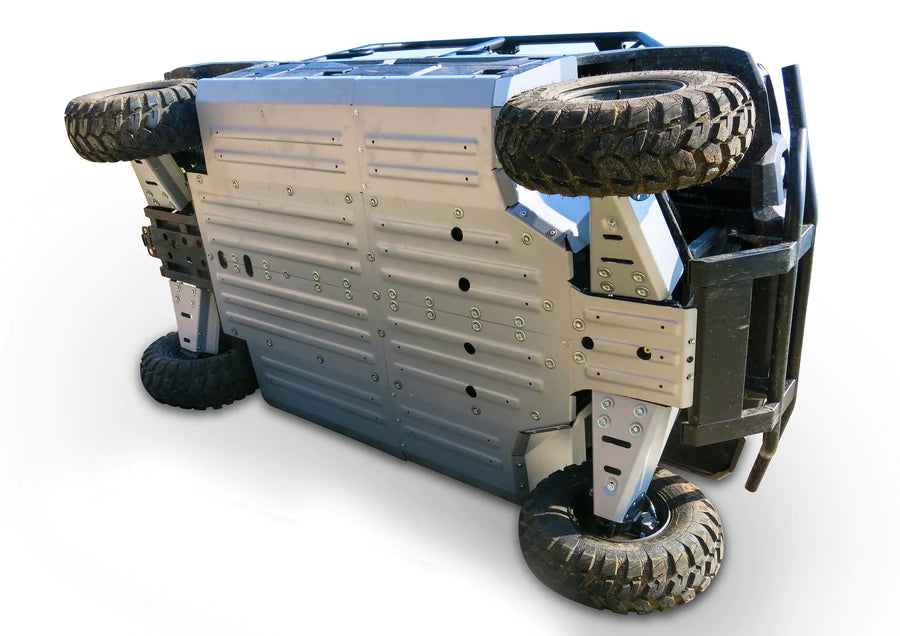 The Kawasaki Mule Pro Dx/Dxt/Fx/Fxt Alloy Central Skid Plate is displayed installed on a rugged off-road vehicle, showcasing its flat, reinforced metal underside and highlighting the product’s sturdy, durable construction.