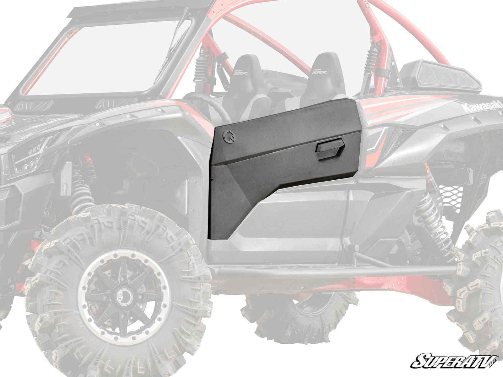 The Kawasaki Teryx KRX Aluminum Door Skin, shown in matte black with an angular design, is installed on the passenger side of a Kawasaki UTV. The door features a molded handle and distinct panel lines, standing out against the faded background vehicle.