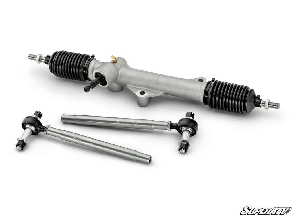 The Kawasaki Mule Pro RackBoss 2.0 Rack and Pinion, featuring black rubber boots and two tie rods, is neatly arranged on a white background with the SuperATV logo visible in the lower right corner. The components appear new.