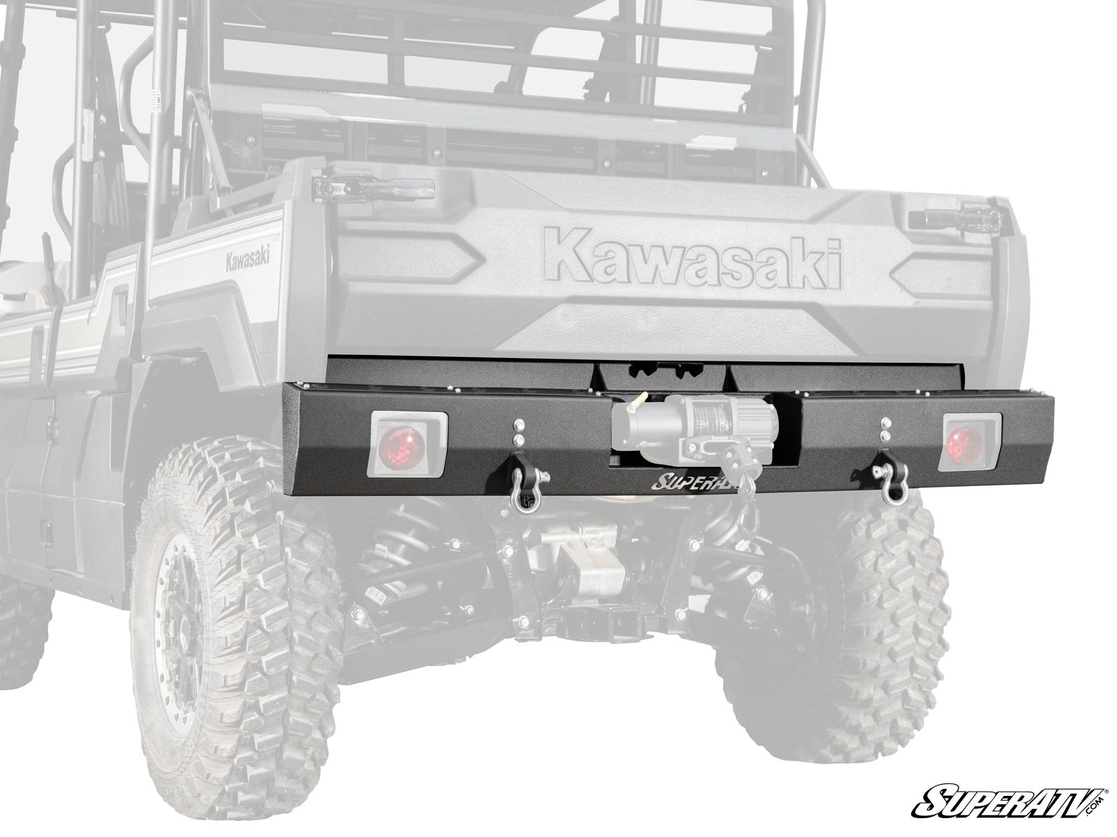 Close-up of a Kawasaki Mule Pro with a Kawasaki Mule Pro Winch Ready Rear Bumper by SuperATV, featuring two D-ring shackles, a center-mounted winch, large rugged tires, and a cargo bed. SuperATV logo appears in the corner.