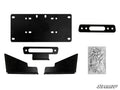 The Kawasaki Mule Pro Winch Mounting Plate includes black metal mounting brackets, a rectangular license plate holder, a winch fairlead plate, corner brackets, and a bag of screws and bolts. SuperATV logo appears in the bottom right on a white background.