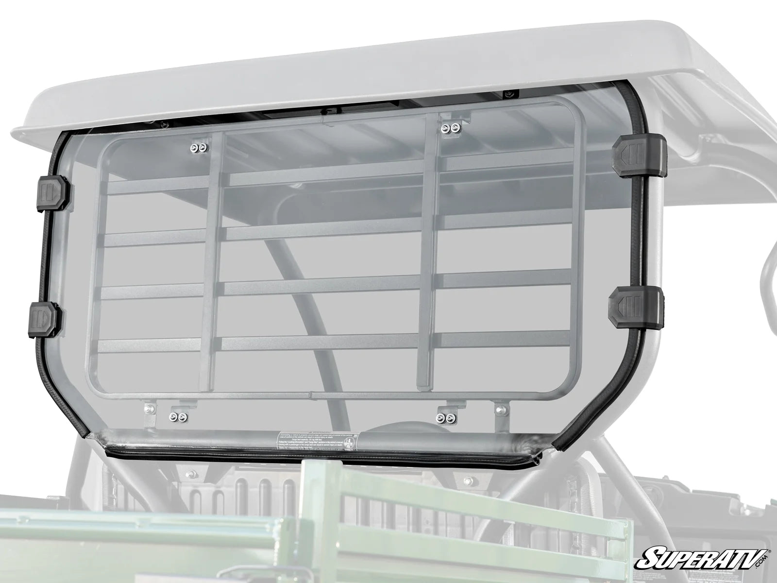 A clear, rectangular polycarbonate Kawasaki Mule SX Rear Windshield with black mounting clamps is attached to the back of an off-road UTV. The SuperATV logo is visible in the bottom right corner of the panel.