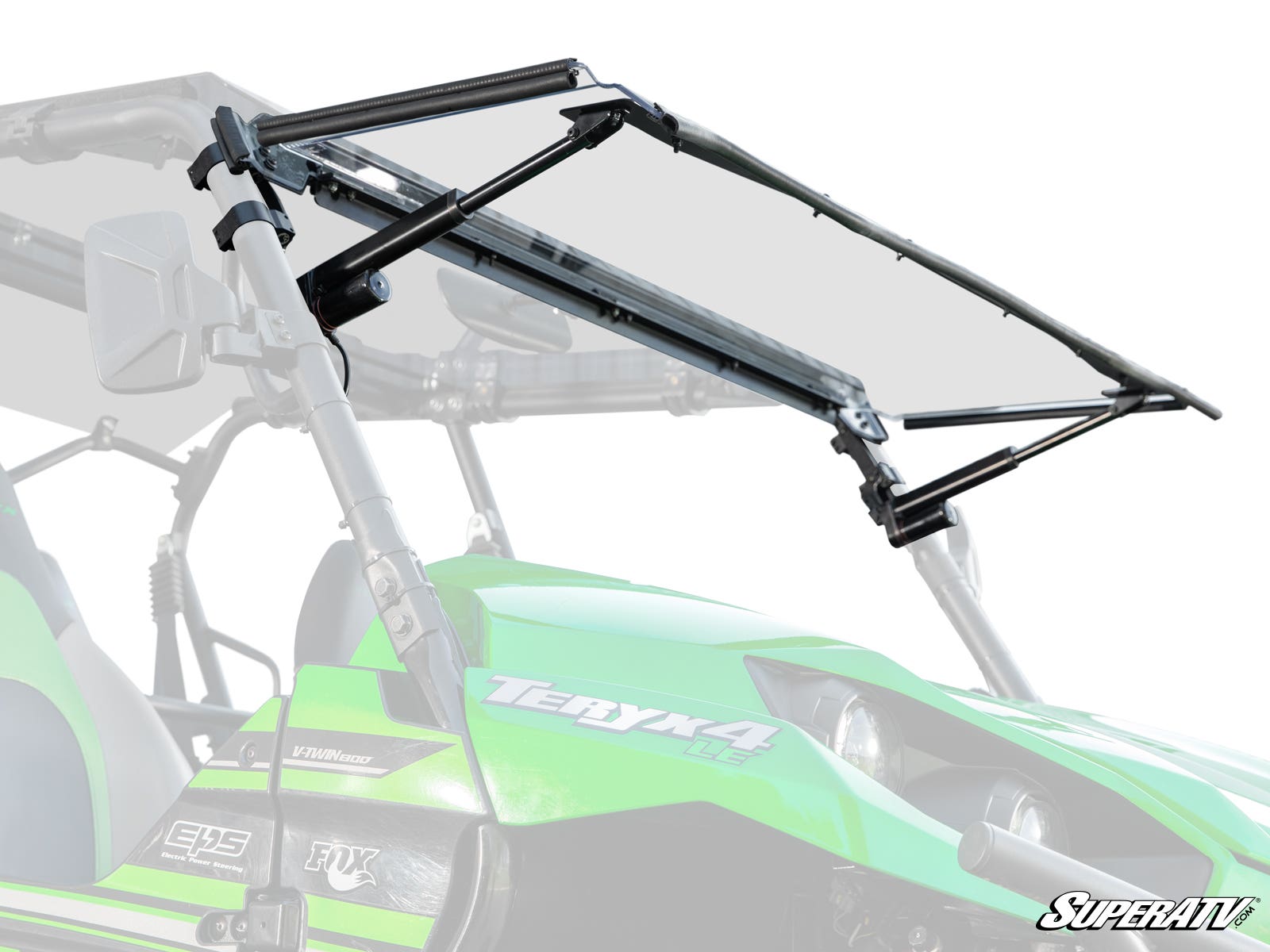 A close-up of a Kawasaki Teryx MaxDrive Power Flip Windshield shows the green off-road vehicle’s transparent windshield partially lifted on black hinges and supports, with the SuperATV logo visible in the bottom right corner.