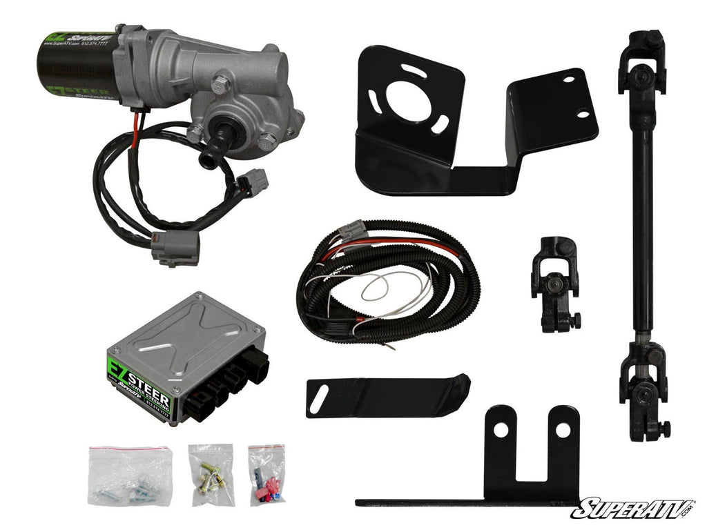 Kawasaki Teryx 4 Power Steering Kit components displayed on a white background, including motor, wiring harness, control box, mounts, brackets, joints, and connector bags. SuperATV logo shown in the bottom right corner.