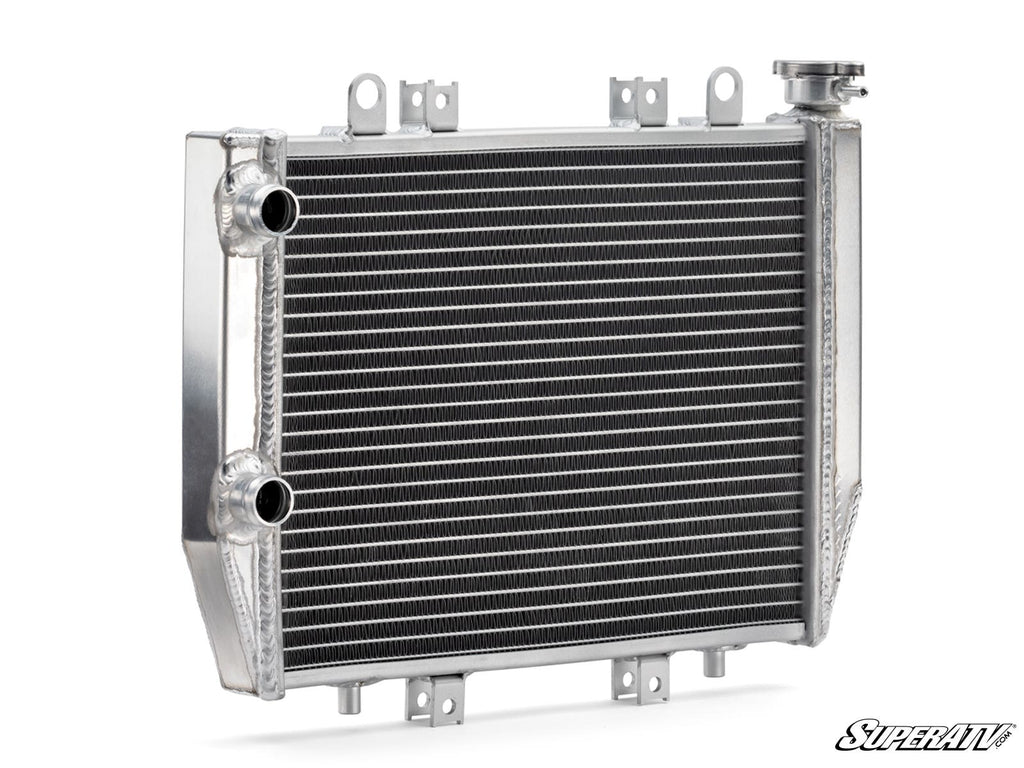 The Up & Running Kawasaki Brute Force 750 Radiator is a shiny, rectangular aluminum ATV radiator with horizontal cooling fins and tubes, left-side inlet and outlet ports, an upper right cap, top and side mounting brackets, and the SuperATV logo at the bot