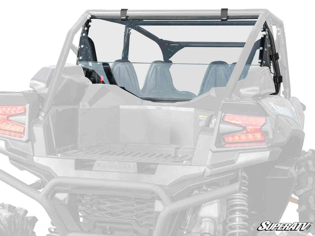 A rear view of a gray Kawasaki Teryx KRX 4 1000 with a clear polycarbonate SuperATV rear windshield, roll cage, two seats, visible taillights, and partial views of the cargo bed and suspension. The SuperATV logo is in the bottom right corner.