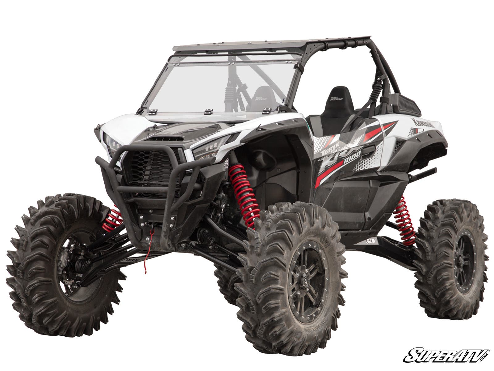 A black and white Kawasaki Teryx KRX 1000 with a 6 Lift Kit, large rugged tires, red coil shocks, a protective front grill, partially open cab, visible suspension system, and SuperATV branding in the lower right corner.