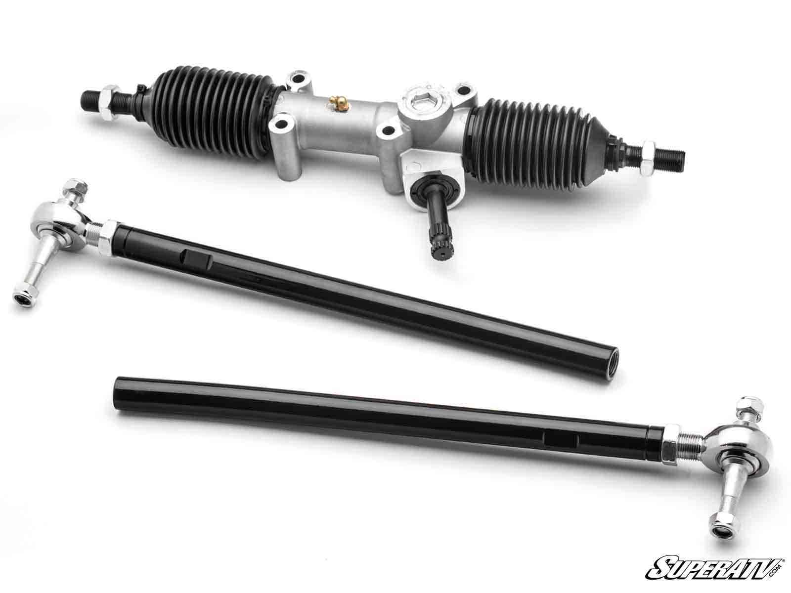 The Kawasaki Teryx KRX 1000 RackBoss 2.0 Rack and Pinion features two black tie rods with silver ends, black rubber boots on each side, and a metallic center section, displayed on a white background with the SuperATV logo in the lower right corner.