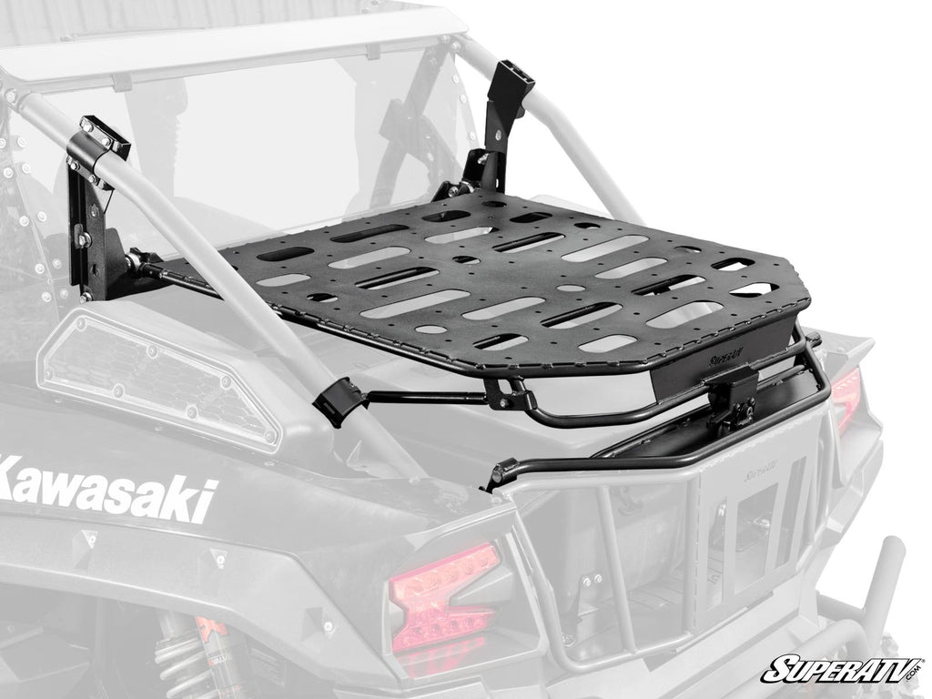 The Kawasaki Teryx KRX 1000 Cargo Rack Alpha is a black, heavy-duty cargo rack mounted on the rear roll cage, featuring multiple oval and round slots for securing gear and sturdy metal brackets supporting it above the cargo bed.