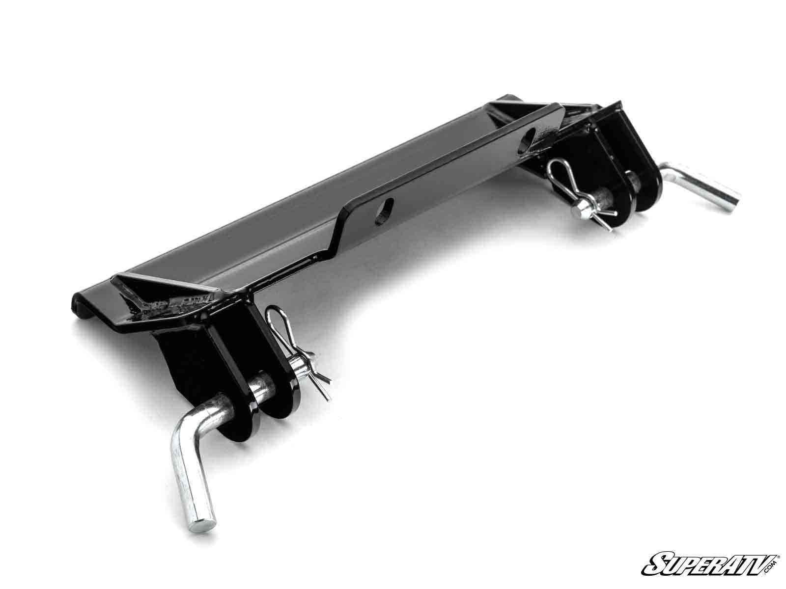 The Kawasaki Teryx KRX 1000 Plow Pro Snow Plow Mount is a black metal bracket with two angled ends, each with a silver pin and cotter pin, a central hole, triangular support plates, and the SuperATV logo on a white background.